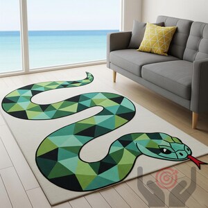 May include: A rectangular area rug featuring a geometric snake design in shades of green, teal, and black against a cream background. The snake's head is detailed with a red tongue and black eyes. The rug is placed on a wooden floor.