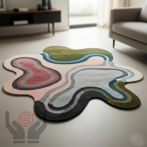 May include: An abstract rug with an irregular shape and a palette of muted colours. The design incorporates flowing lines in shades of pink, green, blue, grey, and black. The rug is placed on a light wooden floor, adding a modern touch to the room's decor.