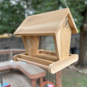 Hand crafted, hanging bird feeder, made of cedar, to keep your feathered friends well fed