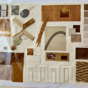 May include: A mood board with various textures and colors, including wood, fabric, and paint swatches. The board features a variety of browns, tans, and creams, with a few pops of gold. The board also includes a small piece of woven fabric, a piece of wood with a cross shape, and a small piece of fabric with a curved shape.