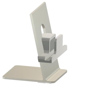 May include: A light gray phone stand with a rectangular base and a vertical support featuring a cutout. The stand has a built-in cradle with a series of vertical slots and a small ledge for holding a phone or tablet.