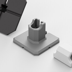 May include: A set of grey and white plastic construction components. The set includes a square base with a central post, a cylindrical piece, and a larger, segmented piece. The pieces are designed to fit together.