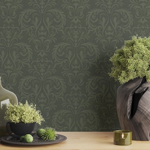 The item is a carved wooden vase with an irregular, organic silhouette. It features a dark brown, pronounced natural grain pattern visible across its curved surface. The vase holds a dense arrangement of narrow green leaves extending outward. The wood appears smoothly finished with subtle texture variations along the carved edges.