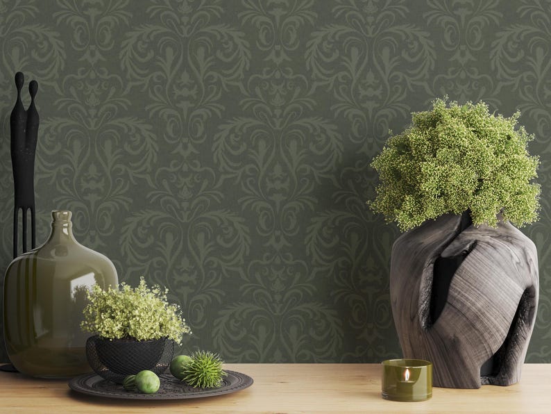 The item is a carved wooden vase with an irregular, organic silhouette. It features a dark brown, pronounced natural grain pattern visible across its curved surface. The vase holds a dense arrangement of narrow green leaves extending outward. The wood appears smoothly finished with subtle texture variations along the carved edges.