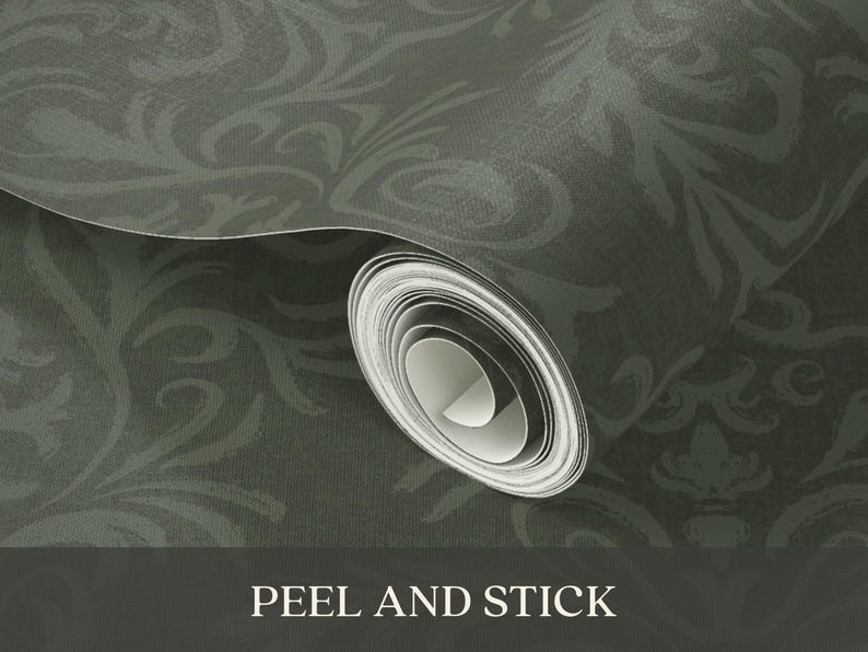 The product is a roll of peel-and-stick wallpaper with a dark, muted green base color. A subtle decorative pattern in a slightly lighter green shade runs across the surface. The material appears to have a smooth, matte texture. The wallpaper is shown in its rolled form, ready for unrolling and application.