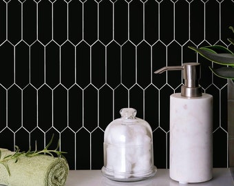 May include: Black and white hexagon tile bathroom wall with a white marble soap dispenser and a glass jar with cotton balls.