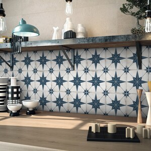 May include: A white tiled backsplash with a navy blue star pattern. The tiles are arranged in a repeating pattern of stars.