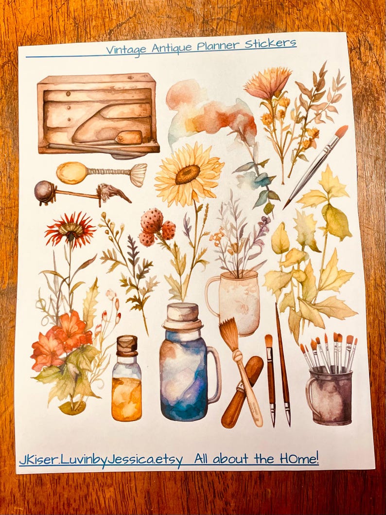 May include: A sheet of planner stickers titled Vintage Antique Planner Stickers featuring watercolor illustrations of a wooden box, a sunflower, wildflowers, paintbrushes in a cup, a glass jar, and a bottle. The bottom text reads JKiser.LuvinbyJessica.etsy All about the HOme!