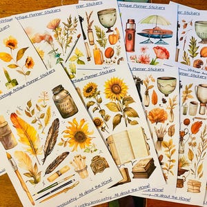 May include: Multiple sheets of planner stickers featuring watercolor illustrations of sunflowers, vintage books, ink bottles, feathers, paintbrushes, and various antique objects. Each sheet is labeled with the text Vintage Antique Planner Stickers.
