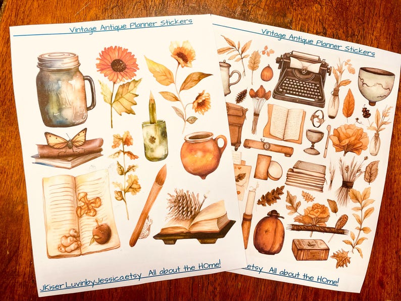 May include: Two sheets of planner stickers featuring watercolor illustrations in warm orange and brown tones. Designs include a mason jar, sunflower, typewriter, books, candle, pottery, pinecone, and leaves. Text reads Vintage Antique Planner Stickers.