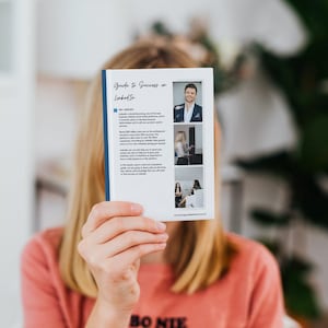May include: A guide to success on LinkedIn, a white booklet with a blue border, featuring a photo of a man in a suit and tie on the cover. The text on the cover reads "Guide to Success on LinkedIn".