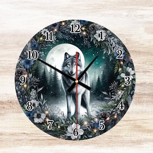 May include: Round wall clock featuring a wolf in a forest scene under a full moon. The clock face has a dark background with a floral border and traditional clock hands. The numbers are in a classic font.