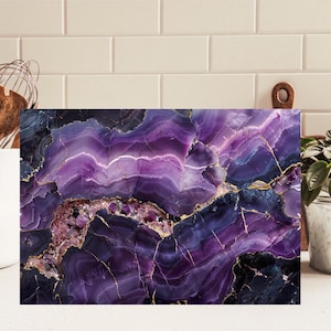 May include: A rectangular cutting board featuring a vibrant purple and deep blue agate stone pattern with intricate gold veining throughout. The surface displays layered crystalline textures and smooth polished sections in shades of violet and dark indigo.