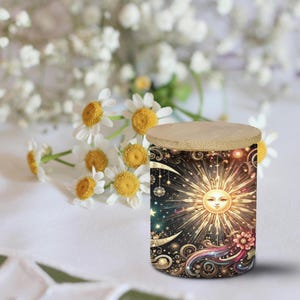 May include: A cylindrical container with a wooden lid, featuring a celestial design with a smiling sun, crescent moons, and stars. The container has a black background with colorful accents and a floral design.
