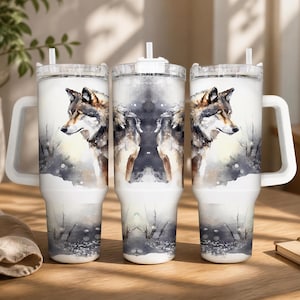 A set of three large, white, insulated tumblers with a water-resistant design featuring a wolf's head printed on them. The tumblers are placed on a wooden surface, with a potted plant and sunglasses visible in the background.
