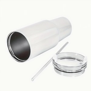 A white, cylindrical container with a clear lid and a straw lying next to it.