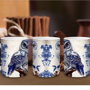 May include: A white ceramic mug featuring a repeating blue and white pattern of an owl perched on a branch, surrounded by floral motifs. The design is displayed on three mugs, showing the owl from the side and a central symmetrical floral element.