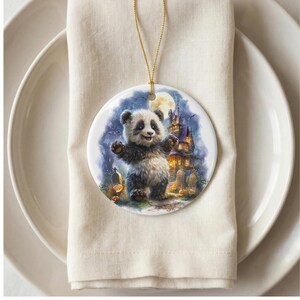 A panda bear standing on its hind legs with a castle in the background, as depicted on a decorative ornament hanging from a string.