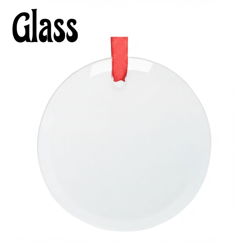 A white, round ornament with a red ribbon hanging from it.