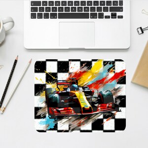 May include: A red and yellow race car speeding across a checkered finish line with colorful paint splatters in the background.