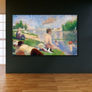 Op de afbeelding: Een ingelijste print van een pointillistisch schilderij dat een zonnige dag aan een rivier toont. Mensen ontspannen op de grasrijke oever en in het water. Het kunstwerk gebruikt een levendig palet van blauw, groen en geel.