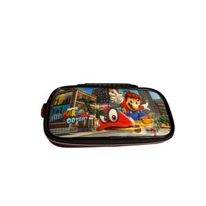 May include: Black pencil case featuring a colorful graphic of Mario from Super Mario Odyssey. The case has a zipper closure and a handle. The graphic includes the text "Super Mario Odyssey" and a cityscape background.