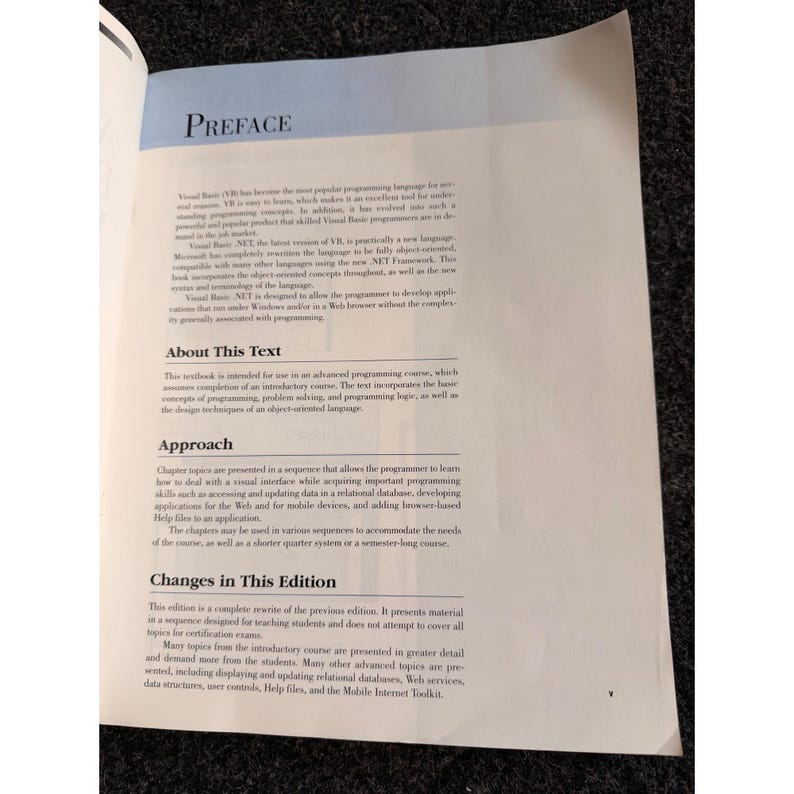 Op de afbeelding: Pagina uit een open boek met de titel "PREFACE". De tekst beschrijft de inhoud van een programmeercursus, inclusief objectgeori&euml;nteerde taal, probleemoplossing en relationele databases. De pagina is wit met zwarte tekst.