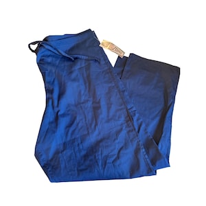 May include: Navy blue scrub trousers with a drawstring waist and a tag attached. The trousers are made of a lightweight fabric and have a relaxed fit. The tag has the brand name "Arizona" printed on it.