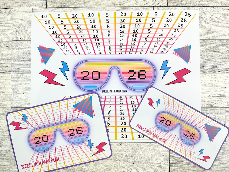 May include: A retro-themed budgeting set featuring a large sheet and two smaller cards. The design includes a grid, sunglasses graphic with the numbers 20 and 26, lightning bolts, and the text "BUDGET WITH AAAA BEAR."