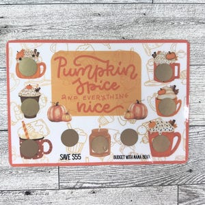 May include: A rectangular, fall-themed design with the text "Pumpkin Spice and Everything Nice." The design features illustrations of pumpkin spice lattes, pumpkins, and a candle. There are several scratch-off circles.