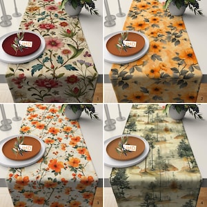 Puede incluir: Cuatro caminos de mesa diferentes con varios diseños florales y de inspiración natural. Los caminos de mesa son todos beige con diferentes patrones florales de colores. El primer camino de mesa tiene un patrón floral rojo, rosa y verde. El segundo camino de mesa tiene un patrón floral amarillo y naranja. El tercer camino de mesa tiene un patrón floral naranja. El cuarto camino de mesa tiene una escena de bosque verde y marrón.