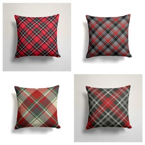 May include: Four square throw pillows with a red, black, and white plaid pattern. The pillows are arranged in a grid pattern.