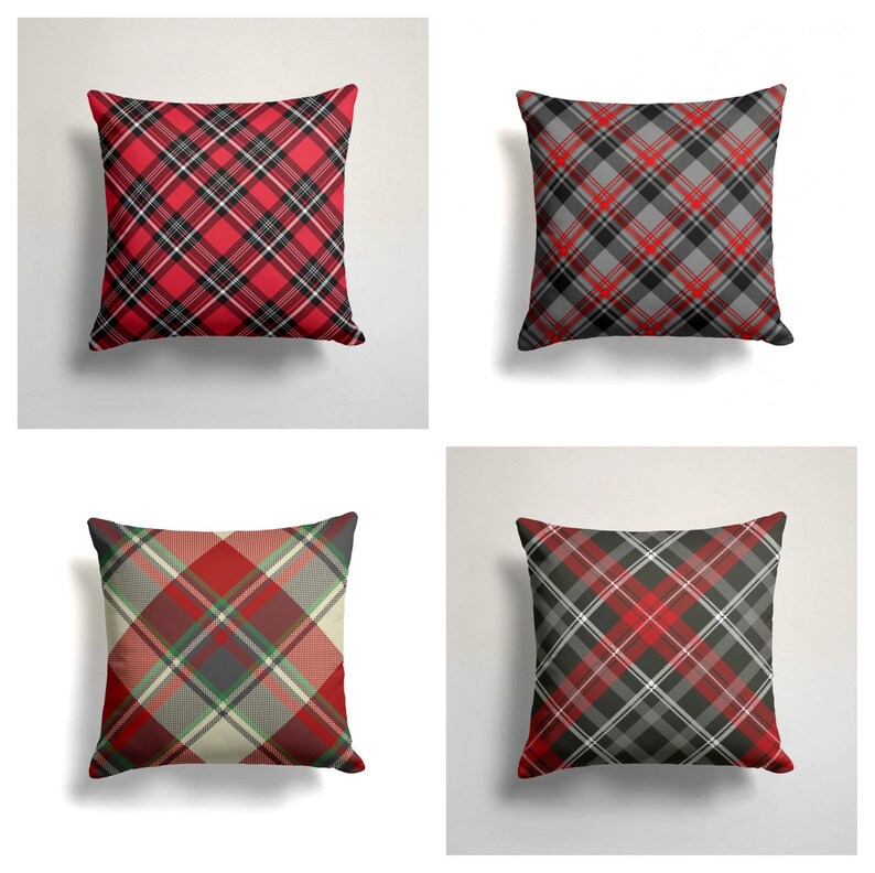 May include: Four square throw pillows with a red, black, and white plaid pattern. The pillows are arranged in a grid pattern.