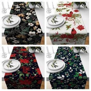 May include: Four different Christmas table runners with various holiday designs. The runners feature red and green poinsettias, holly, bells, and cardinals on a black, white, or dark green background.