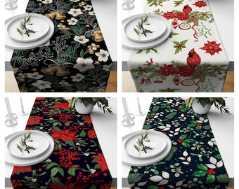 May include: Four different Christmas table runners with various holiday designs. The runners feature red and green poinsettias, holly, bells, and cardinals on a black, white, or dark green background.
