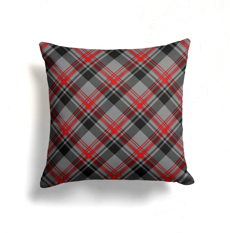 May include: A gray and red plaid throw pillow with a square shape.