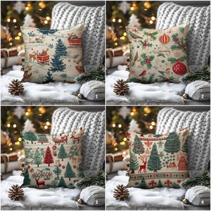 May include: Four decorative Christmas throw pillows with festive designs. Pillows feature holiday scenes with reindeer, trees, ornaments, and winter motifs in red, green, and blue on a cream background. The pillows are displayed on a white surface with pine cones.