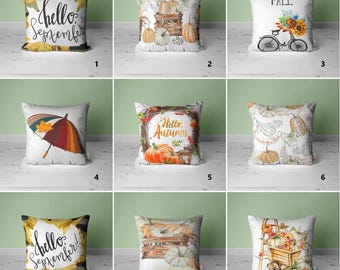 May include: Collection of decorative throw pillows with autumn themes. Designs include pumpkins, fall foliage, and text like "Hello September" and "Welcome Fall." Pillows feature various colors and patterns, perfect for seasonal home decor.