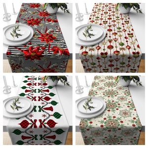 May include: Four different Christmas table runners with various designs. The first runner features a red and white striped background with poinsettia flowers. The second runner has a white background with red and green ornaments. The third runner has a white background with red and green plaid bows and snowflakes. The fourth runner has a cream background with green and red snowflakes.