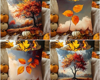 Può includere: Set di quattro cuscini decorativi con disegni a tema autunnale. Ogni cuscino presenta un dipinto di paesaggio diverso di fogliame autunnale, alberi e un cielo nuvoloso. Zucca e foglie circondano i cuscini, creando un'estetica autunnale accogliente.