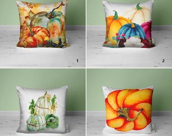 May include: Four different pillow designs featuring watercolor illustrations of pumpkins. The pillows are white with a variety of pumpkin colors and designs.