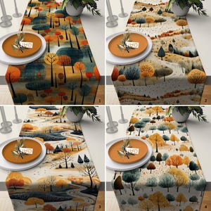 May include: Four table runners with autumnal tree designs. Each runner depicts a different landscape with trees in shades of orange, yellow, green, and blue. The runners are paired with orange plates and white plates, and a vase of greenery.