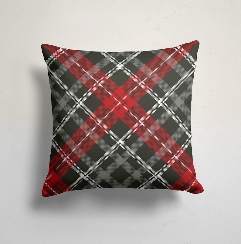 May include: Red, black, and white plaid throw pillow. The pillow is made of a soft, comfortable fabric and has a square shape.
