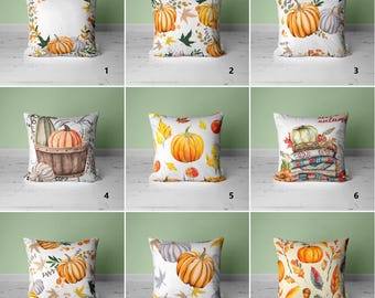 May include: Nine different pillow designs featuring various autumnal themes. The pillows are all square and have a white background with colorful designs. Some designs feature pumpkins, leaves, and acorns, while others feature a stack of blankets with the word "autumn" written on them.