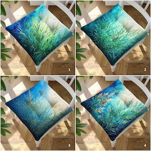 May include: A square seat cushion featuring a vibrant watercolor-style print of aquatic plants in shades of deep blue, teal, and bright green. The design includes four distinct variations labeled with numbers one through four in the corners.