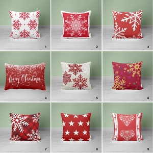 May include: Nine different Christmas cushion designs featuring snowflakes, stars, hearts, and a Merry Christmas message. The cushions are all red and white with a variety of patterns.