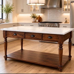 May include: A kitchen island featuring a rectangular white marble countertop with grey veining, a dark brown wooden base with three drawers, black metal cup pulls, four turned legs, and a lower open shelf for storage in a kitchen setting.