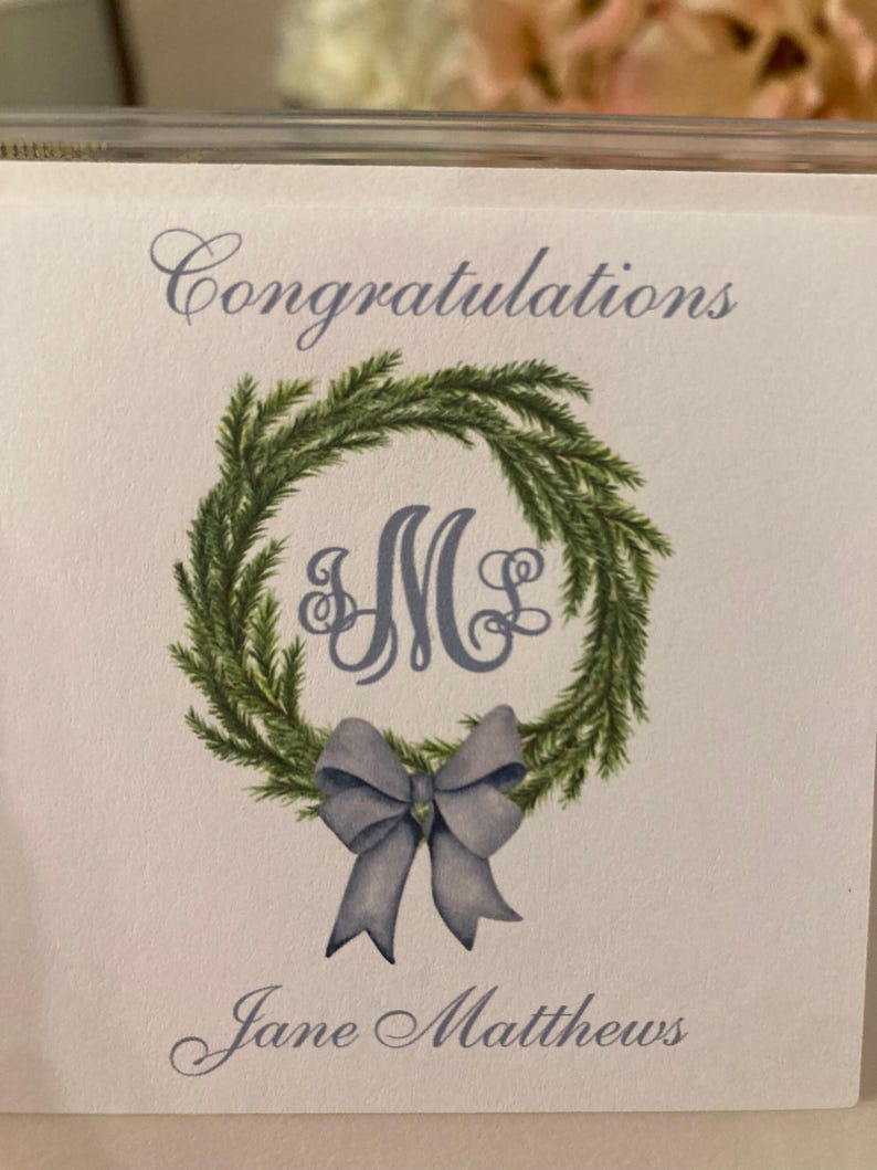 Christmas gift tag with monogram, green wreath, blue bow. Customize with your initials and text of your choice. Merry Christmas or Happy Holidays on top of card with your name at bottom of card. Use for elegant gift tags for the holidays