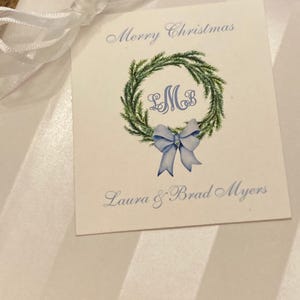 Christmas gift tag with monogram, green wreath, blue bow. Customize with your initials and text of your choice. Merry Christmas or Happy Holidays on top of card with your name at bottom of card. Use for elegant gift tags for the holidays