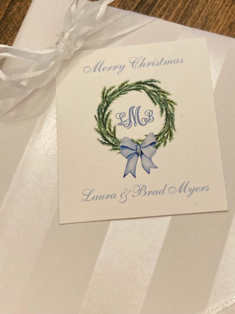 Christmas gift tag with monogram, green wreath, blue bow. Customize with your initials and text of your choice. Merry Christmas or Happy Holidays on top of card with your name at bottom of card. Use for elegant gift tags for the holidays